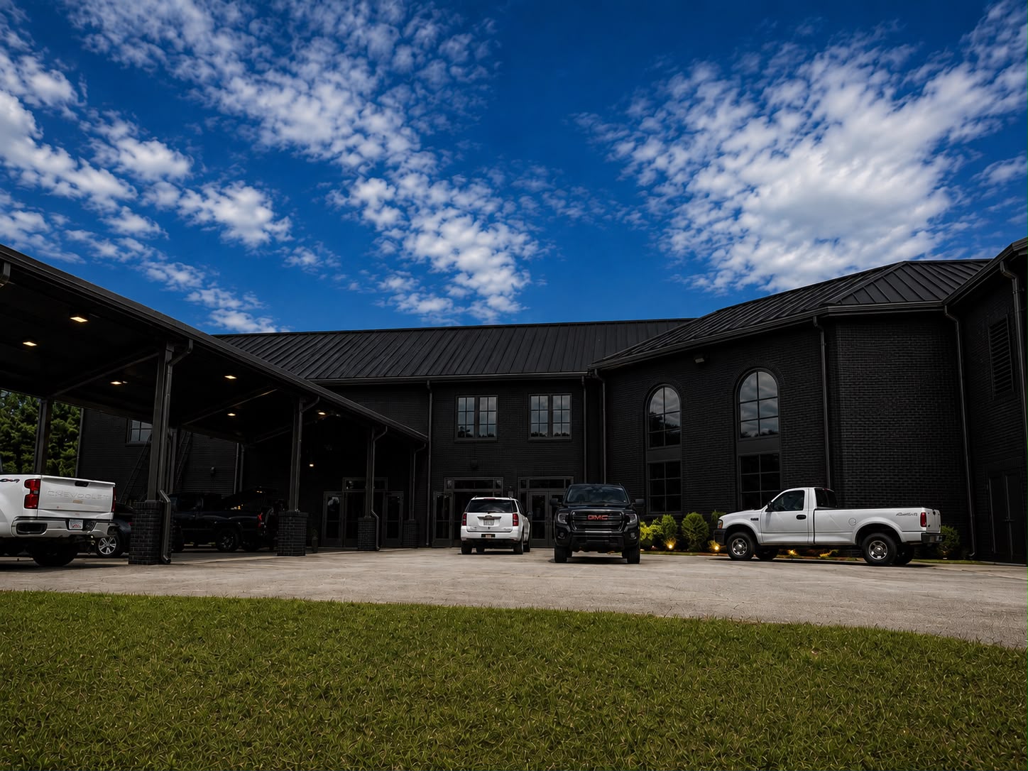 Black brick exterior of Invictus Event Center under a bright Atlanta sky